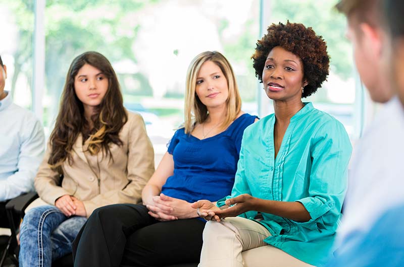 Woman talking in therapy group
