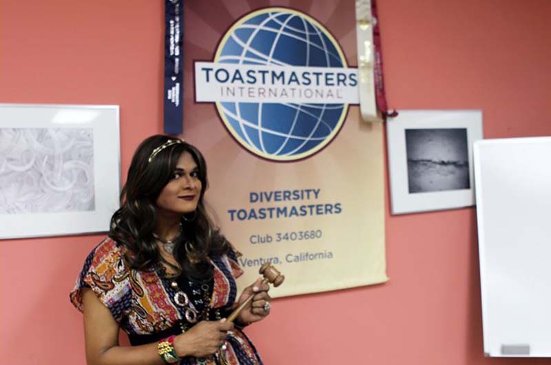 Woman in front of Toastmasters sign