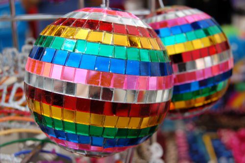 Colorful mosaic glass disco balls on display.